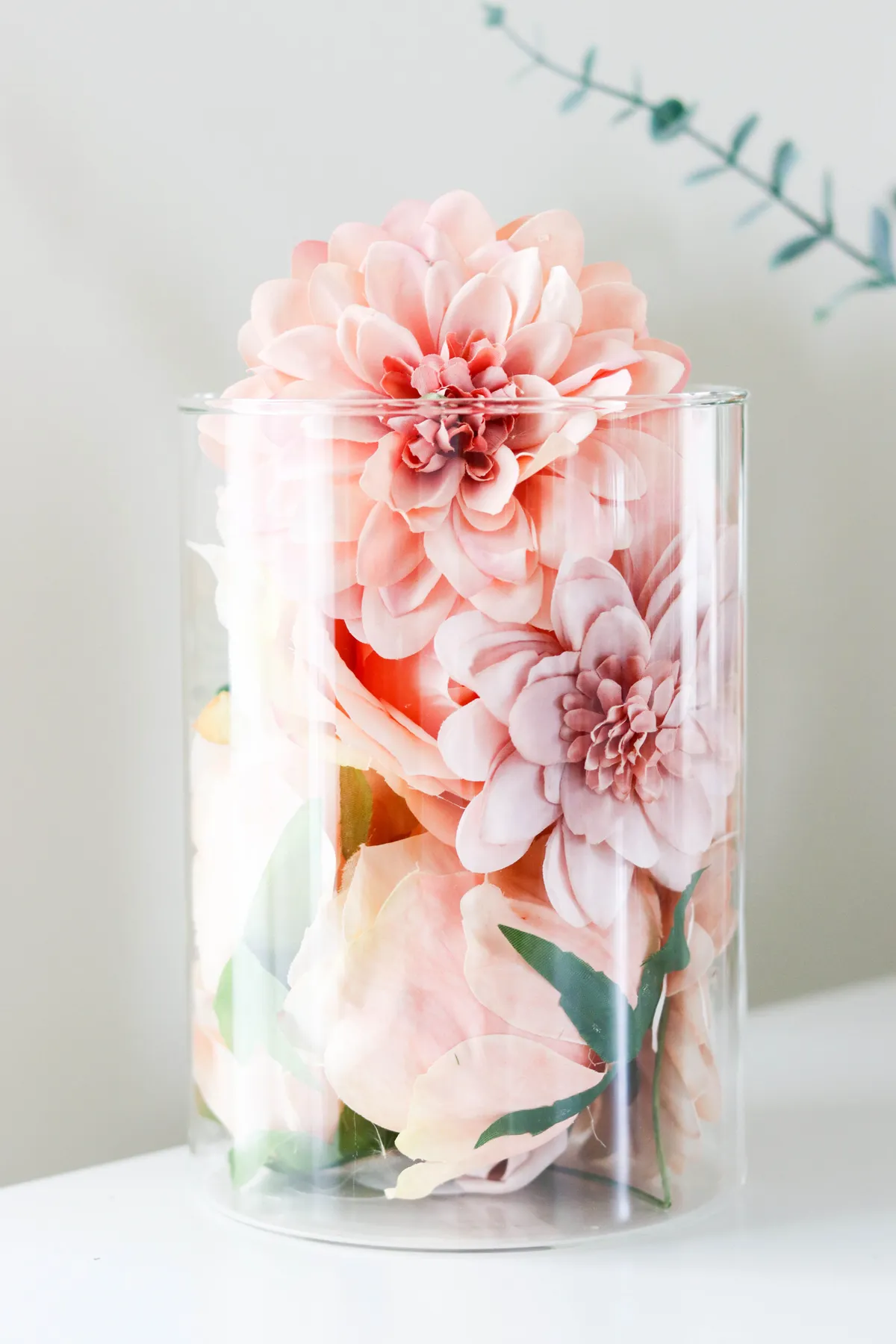 Beautiful artificial pink flowers elegantly arranged in a clear glass vase, perfect for home decor inspiration.