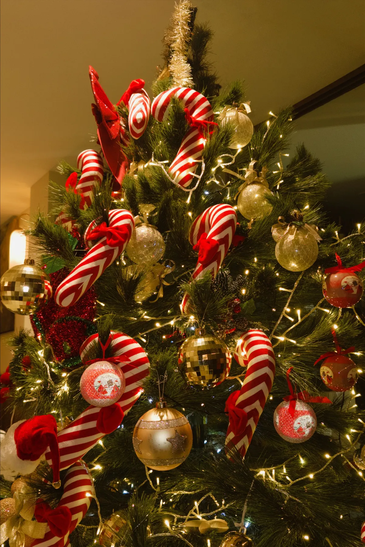 Beautifully decorated Christmas tree with candy canes and glowing lights, perfect for holiday cheer.