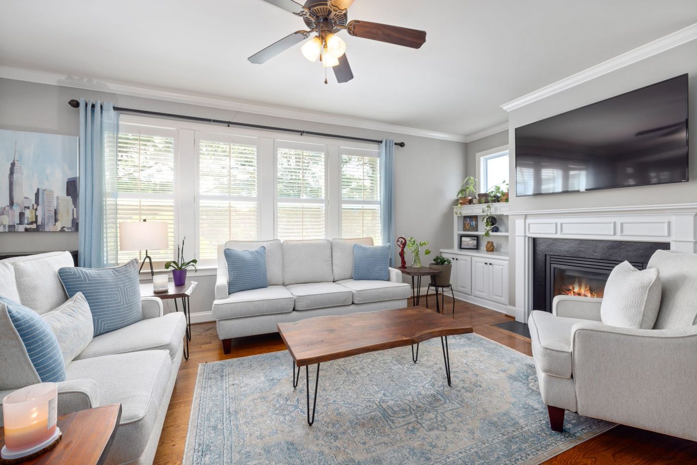 Bright and modern living room interior with fireplace and elegant furniture setup.