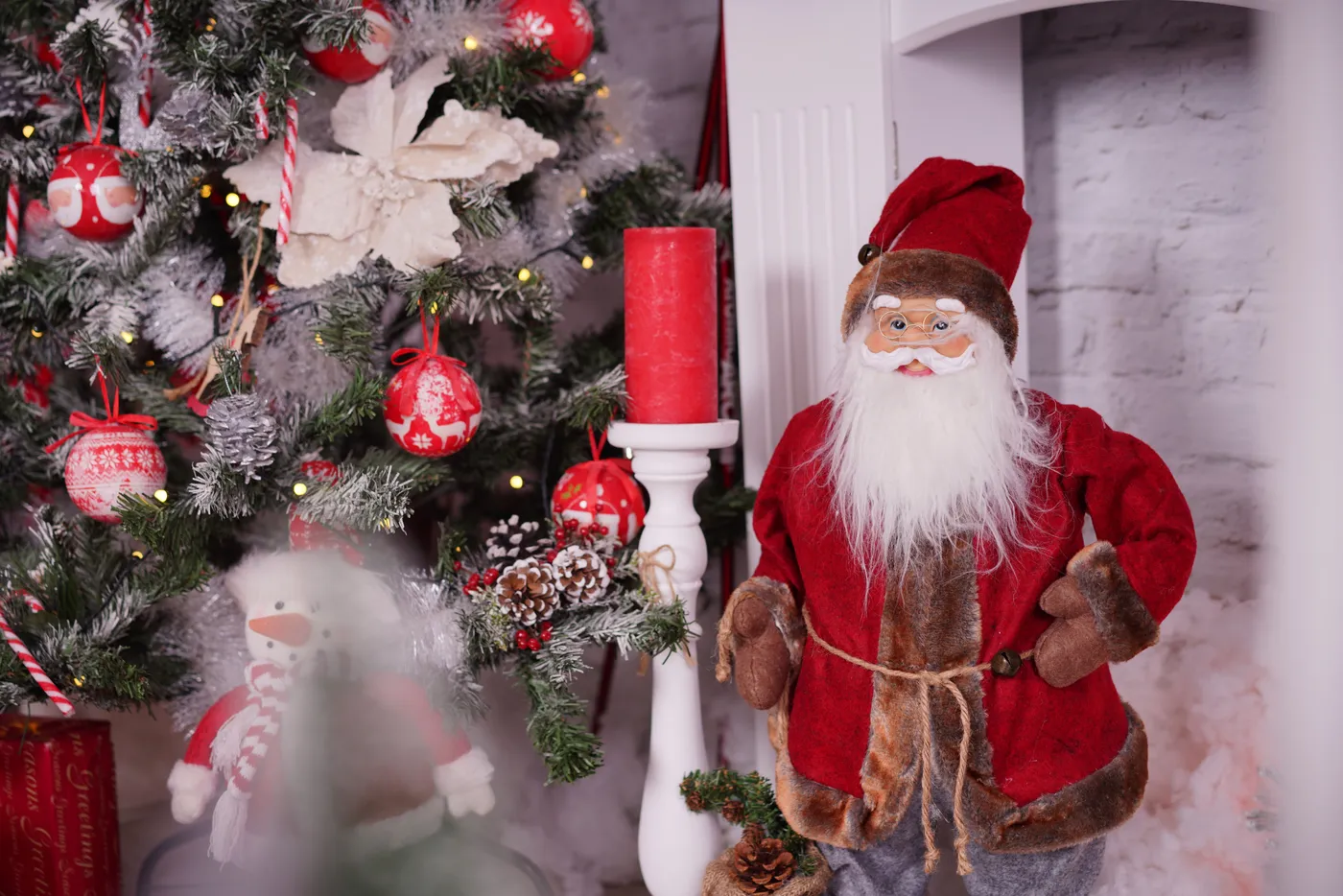Charming Christmas setup featuring a Santa figurine and decorated tree.