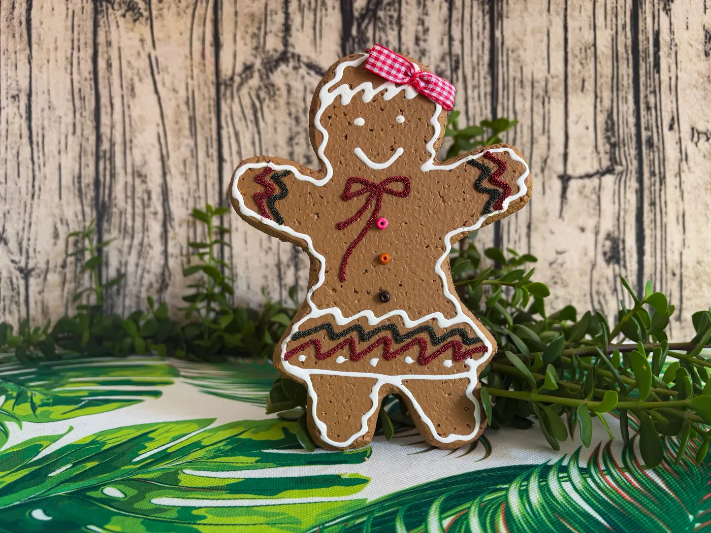 Charming gingerbread cookie with a bow amidst a holiday-themed background, perfect for Christmas decor.
