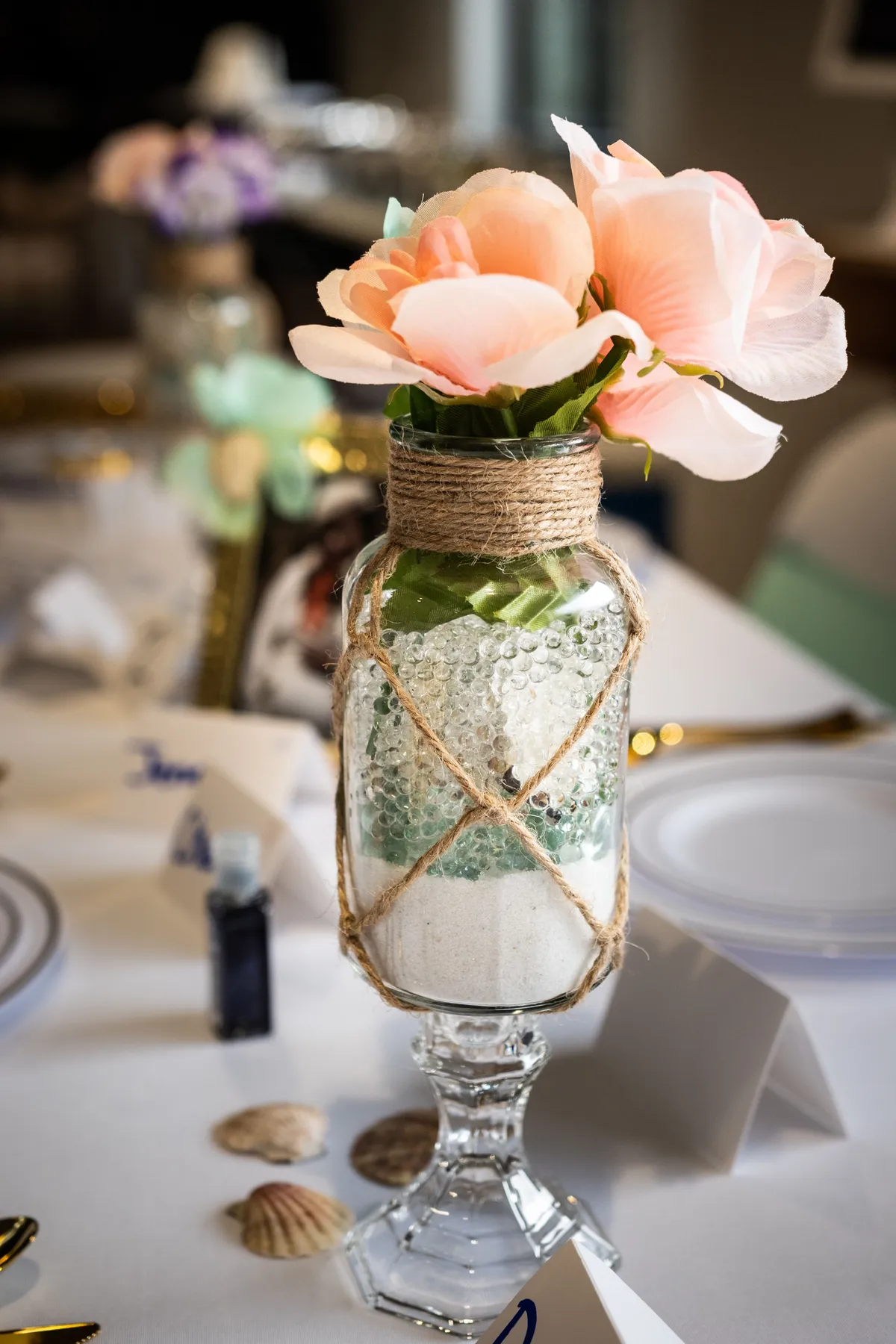 Chic floral arrangement in jar as table centerpiece at event.