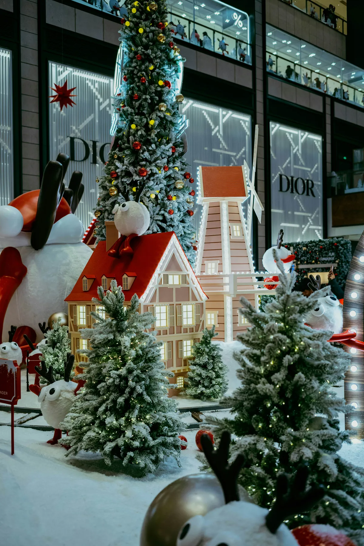 Christmas village display with decorated trees and houses