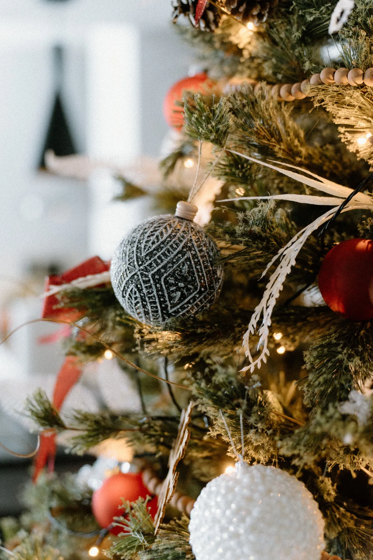 Close-up of a beautifully decorated Christmas tree with intricate ornaments and lights.