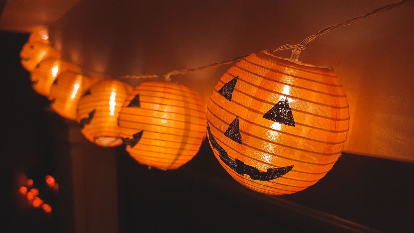 Close-up of festive Halloween pumpkin lantern string lights indoors.