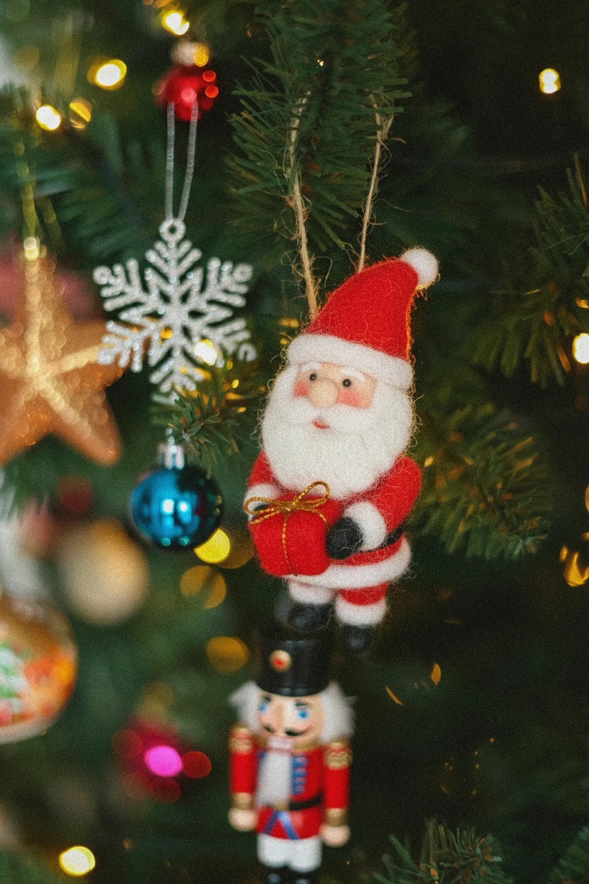 Cozy Christmas tree adorned with Santa and festive decorations.