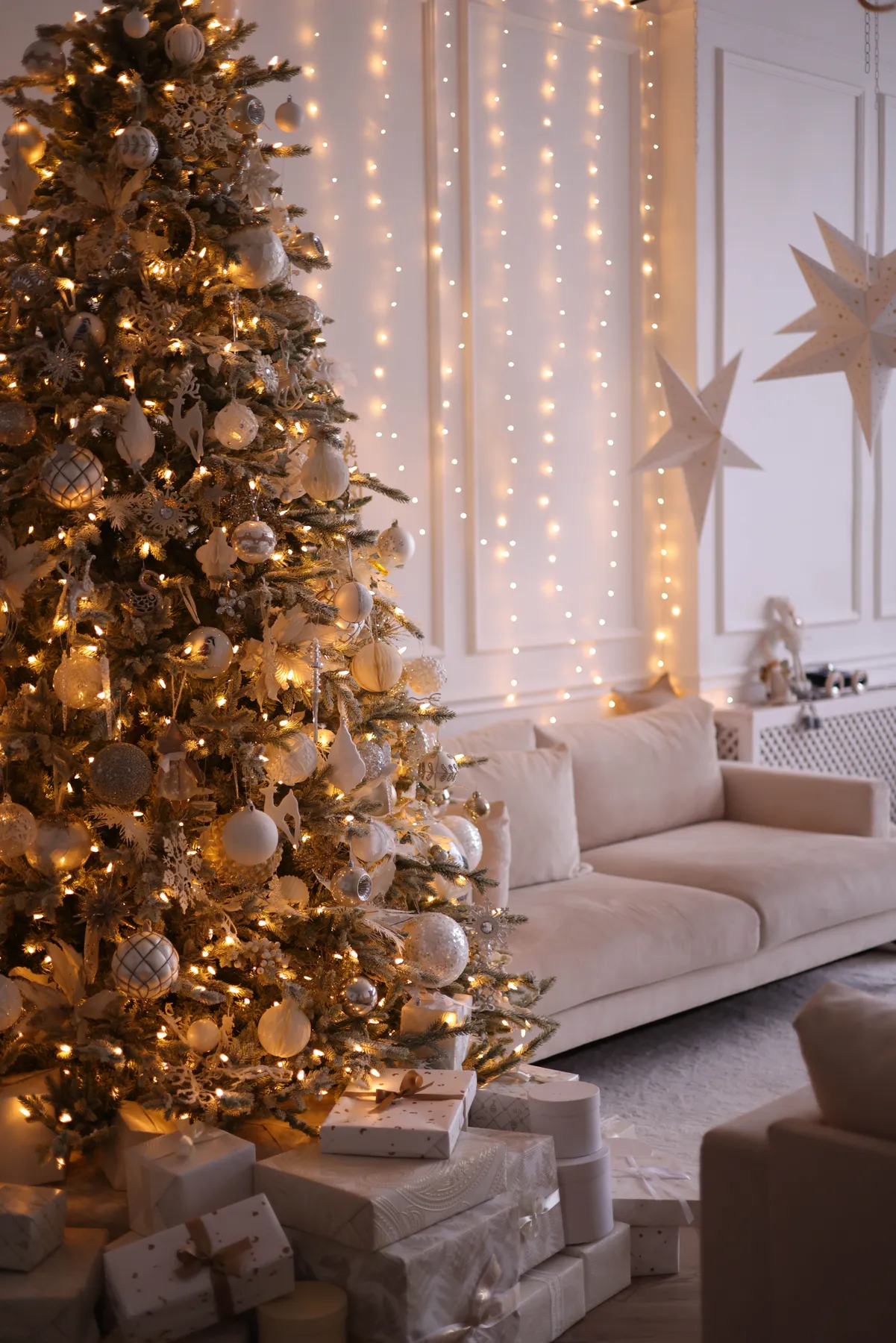 Cozy living room with a decorated Christmas tree and warm festive lighting.