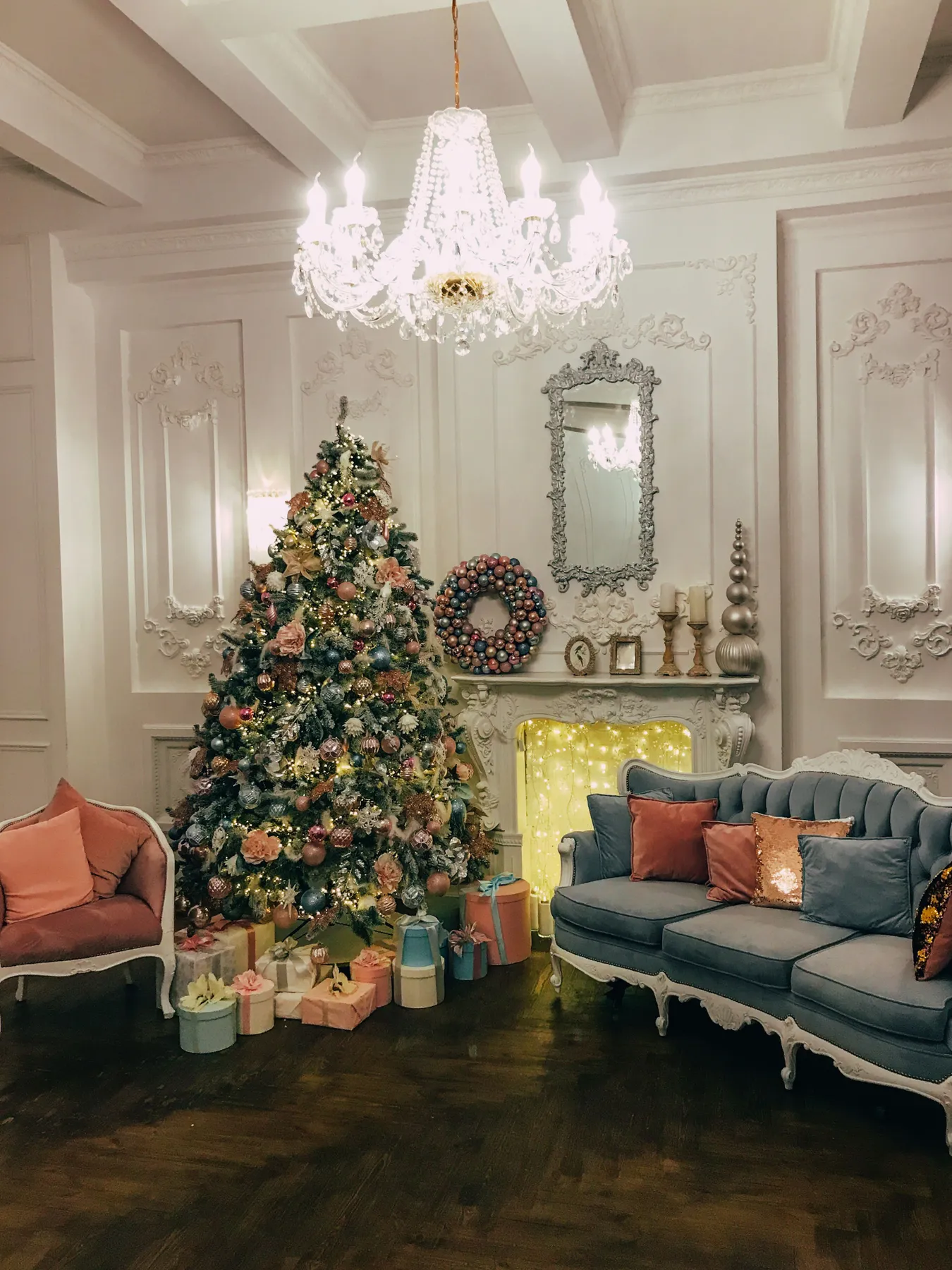 Cozy room featuring a beautifully decorated Christmas tree and a vintage chic sofa setting.