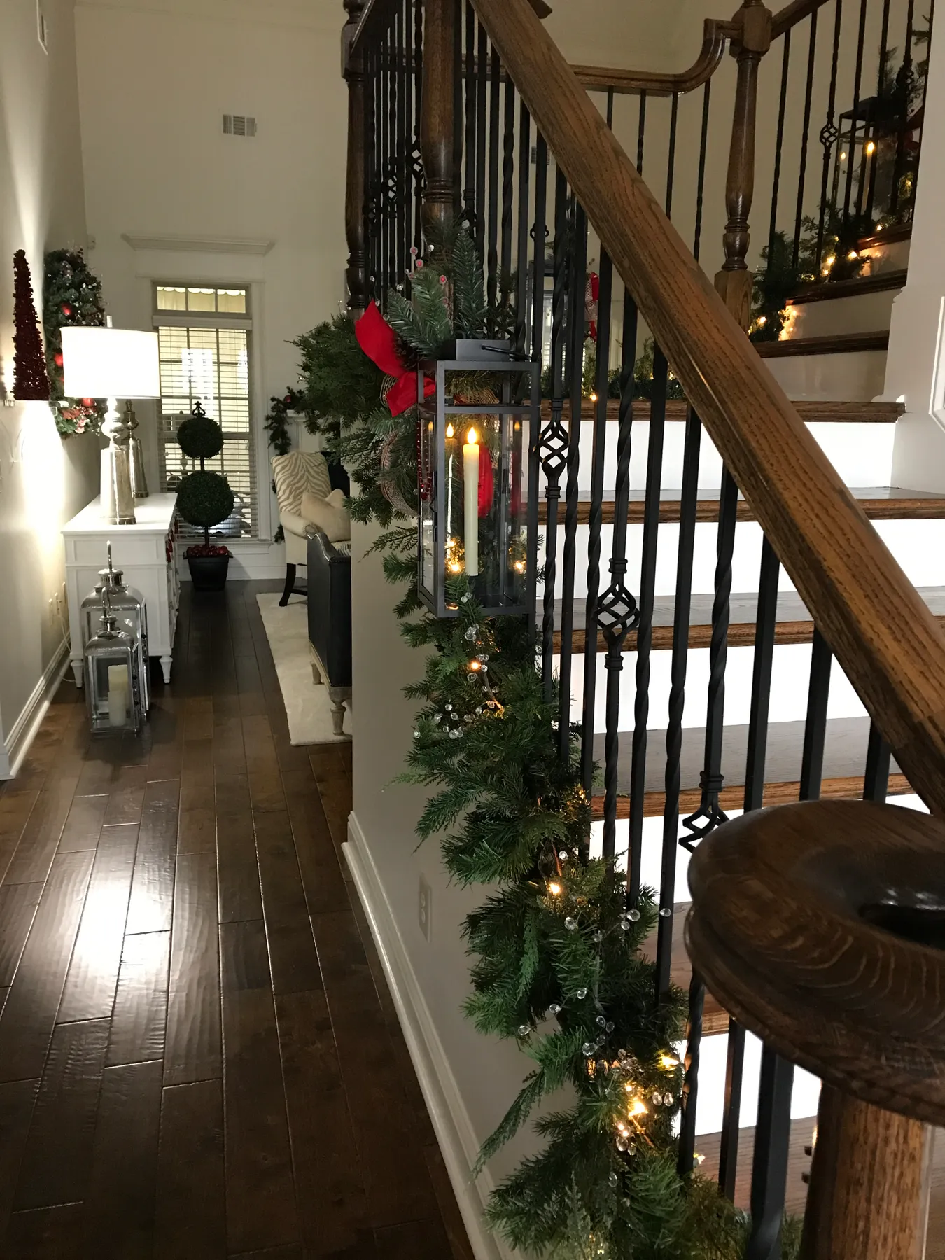 Decorating The Stairs With Christmas Garland And Lanterns