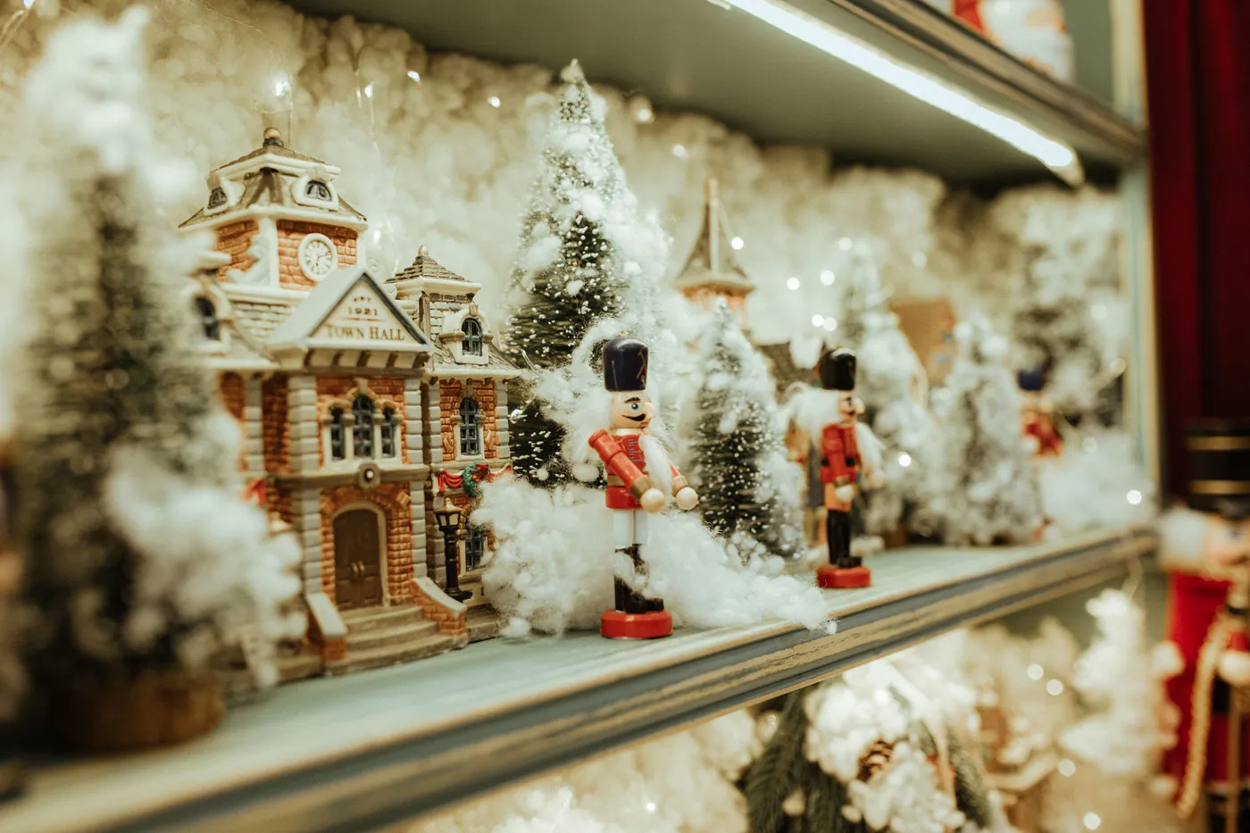 Detailed Christmas village display featuring nutcrackers and snowy decorations.