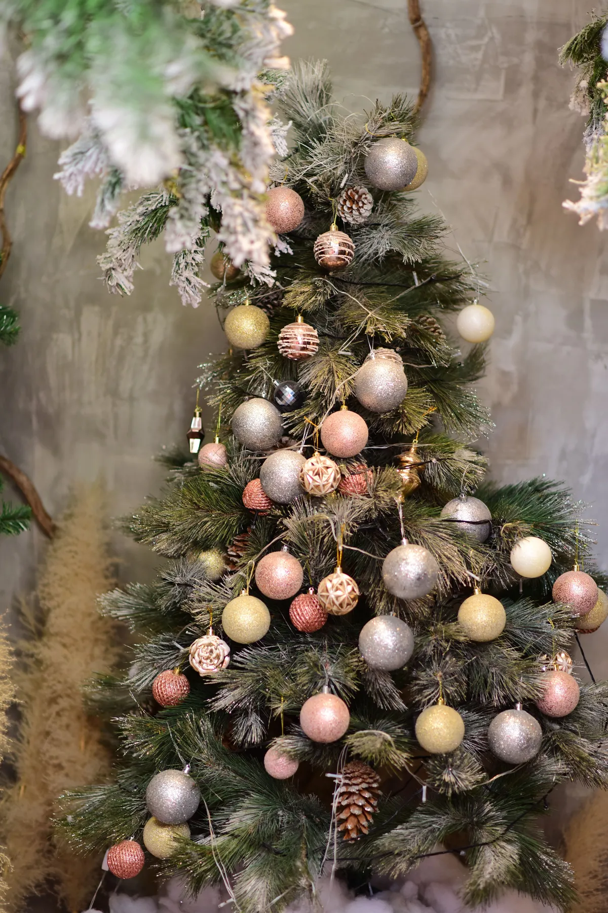 Elegant Christmas tree with shimmering ornaments indoors, creating a festive atmosphere.
