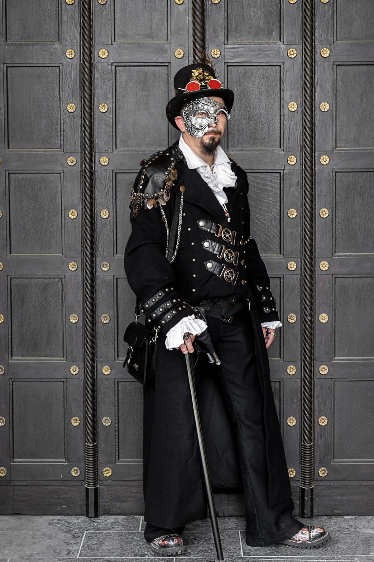 Elegant man in steampunk costume and mask at Leipzig carnival.