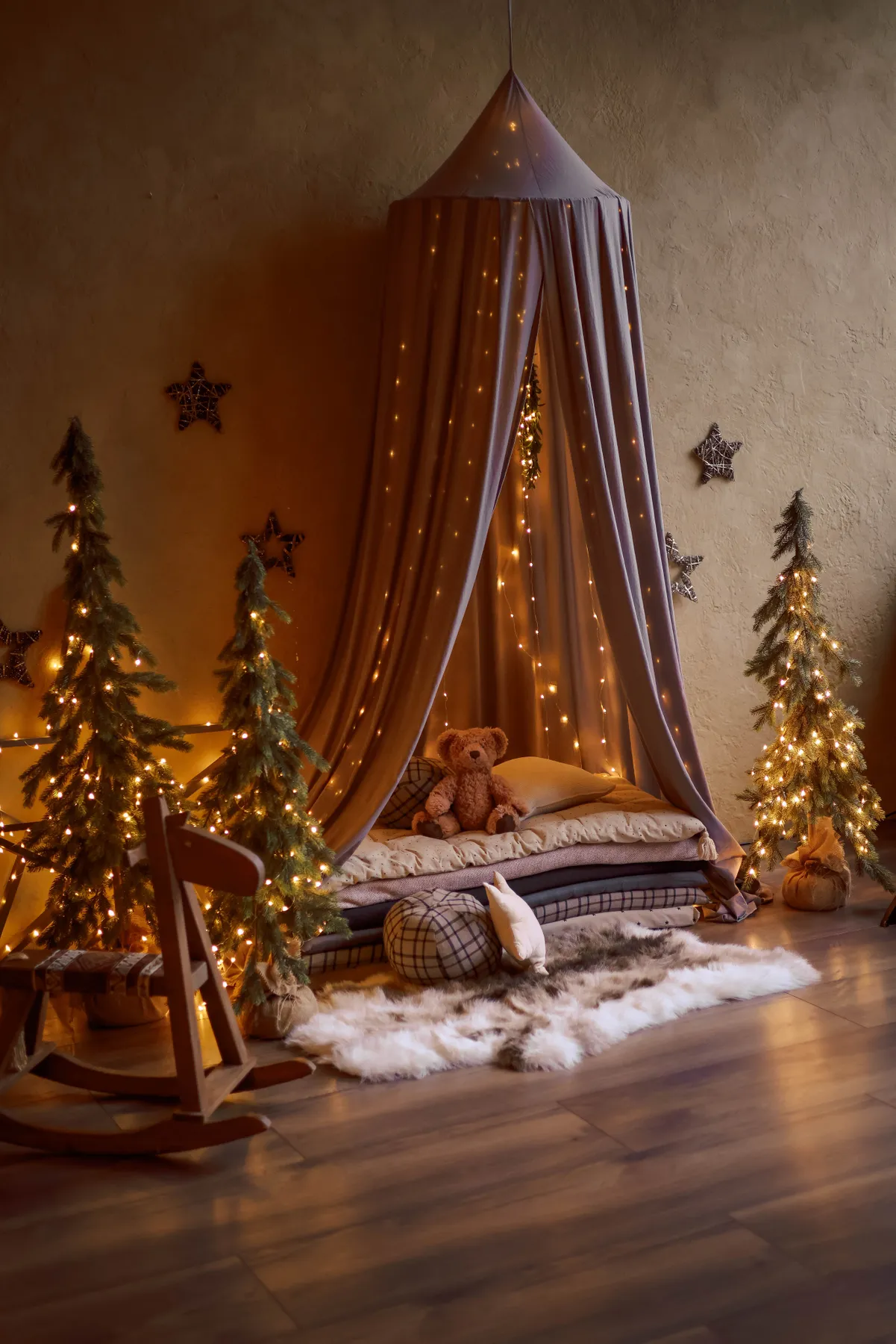 Festive children's bedroom with Christmas lights and plush toys, creating a whimsical atmosphere.