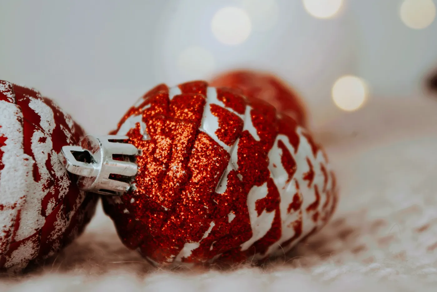 Festive red and white Christmas ornaments with a blurred background.