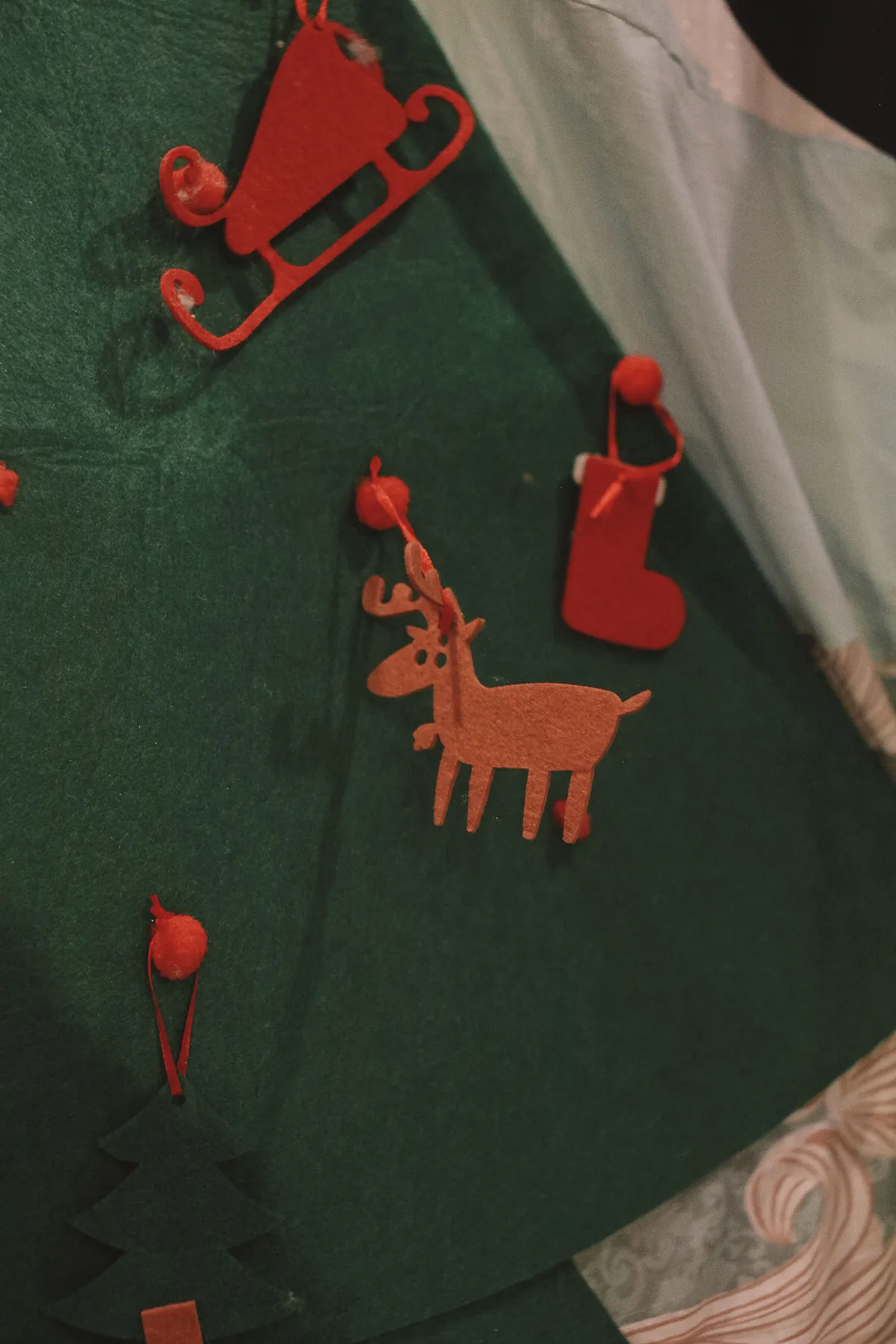 Handcrafted Christmas ornaments made from felt creating festive decor.