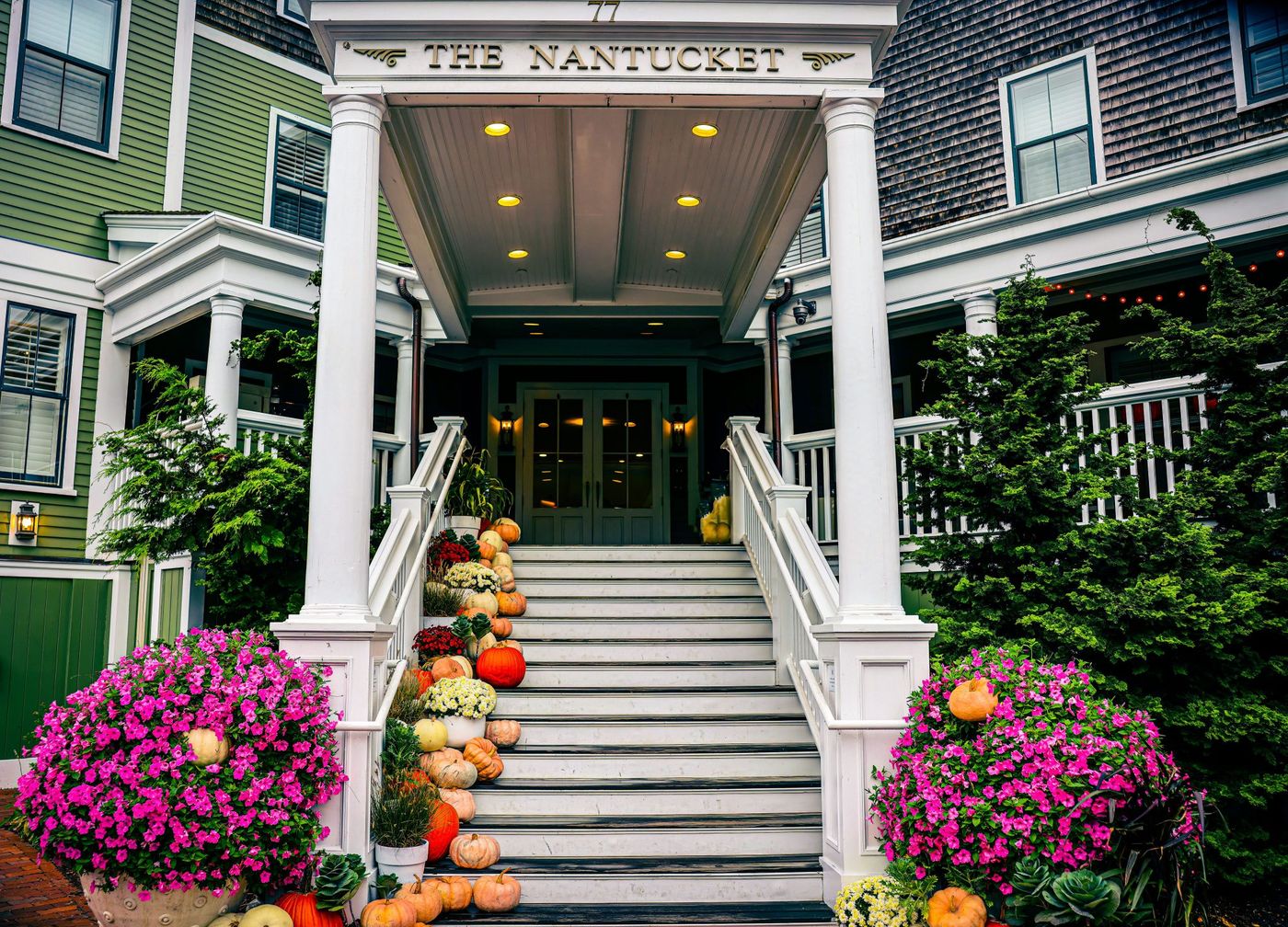 Inviting staircase decorated with pumpkins in Nantucket during fall season.