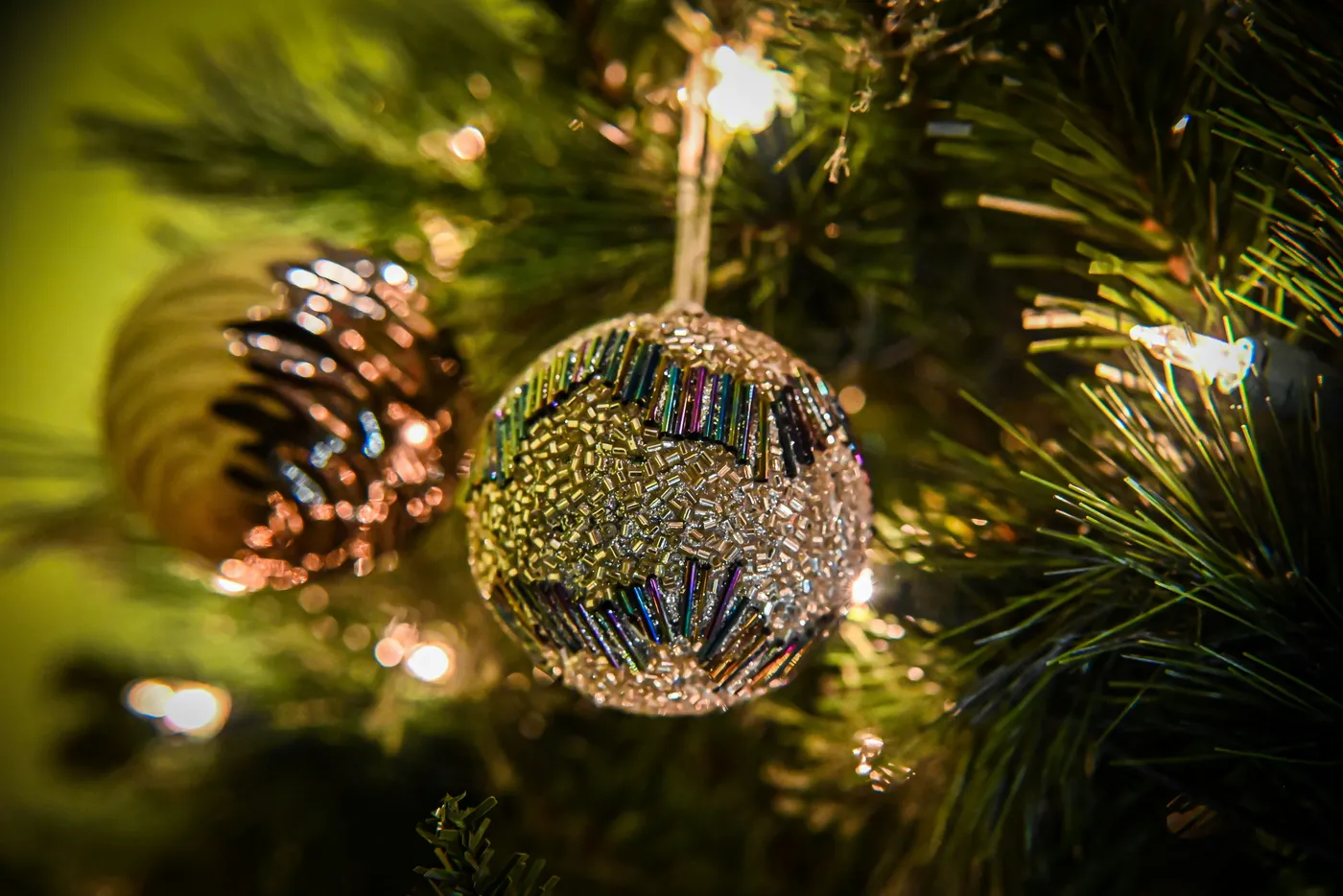 Metallic colored ball ornaments hanging on a tree