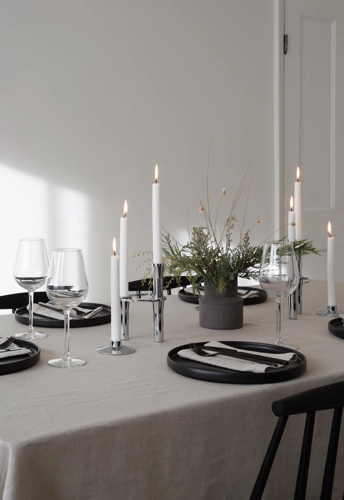 Minimalist Christmas table styling with festive foliage |