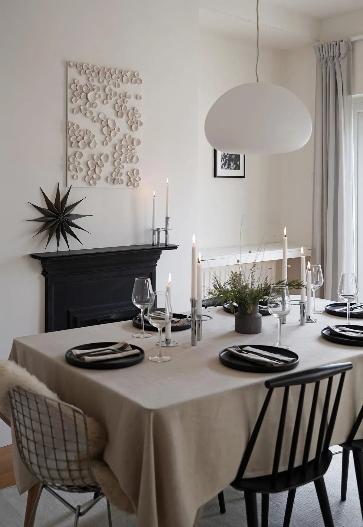 Minimalist Christmas table styling with festive foliage |