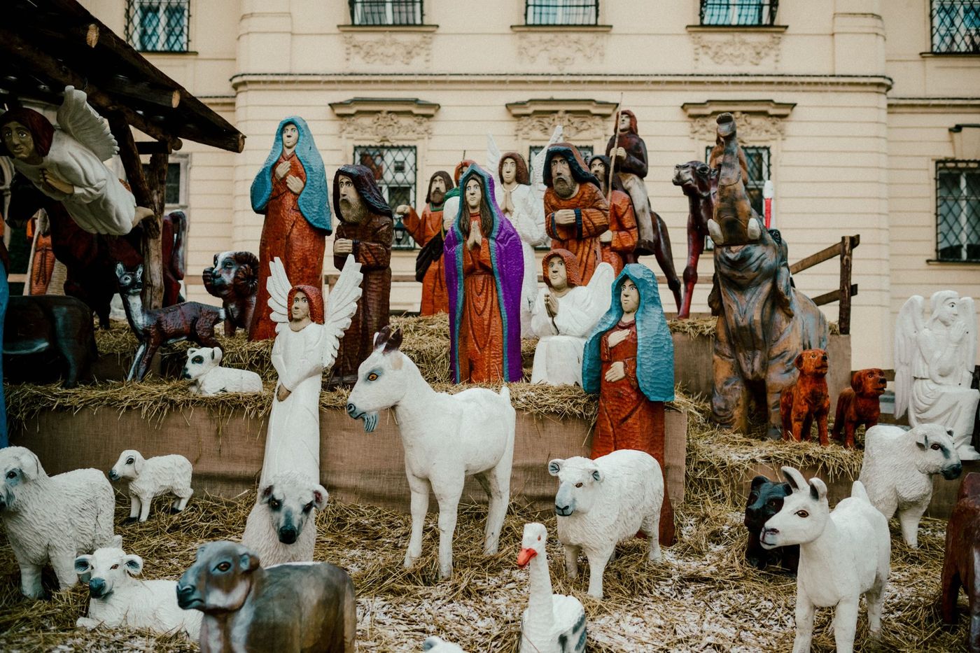 Outdoor display of a traditional Christmas nativity scene with figurines depicting the birth of Jesus.
