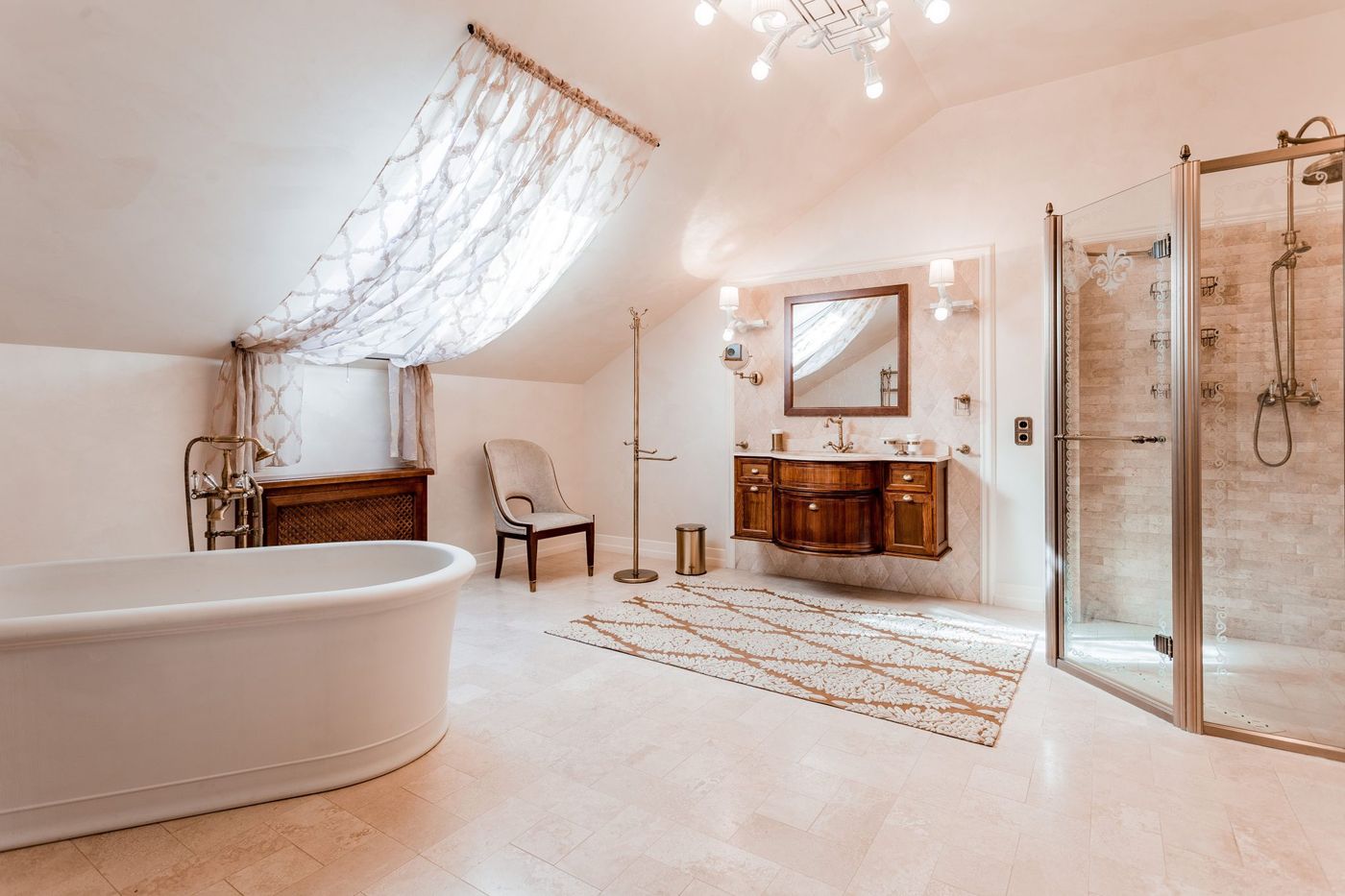 Spacious and elegant attic bathroom featuring a freestanding tub and glass shower.
