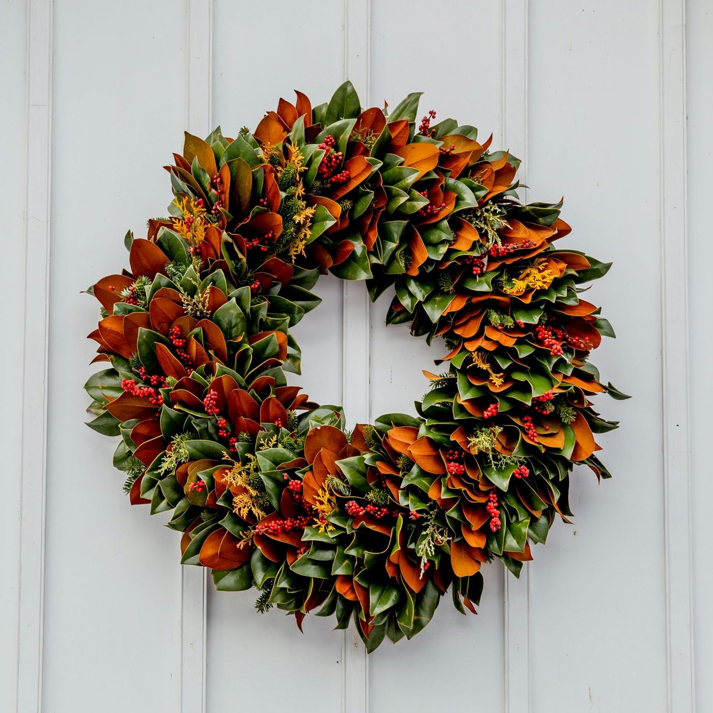 This beautiful wreath is made from all natural items with the focus being magnolia tree leaves turned forward and backwards to create the stunning color composition. Seen at the historic Old City Ceme