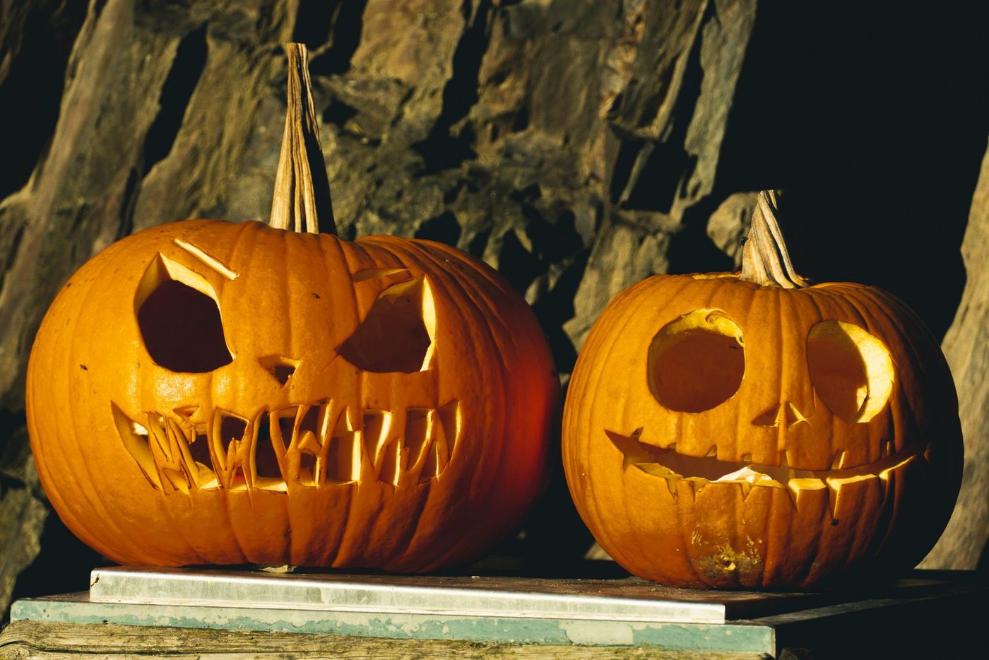 Two carved pumpkins create a spooky Halloween atmosphere, perfect for autumn decorations.