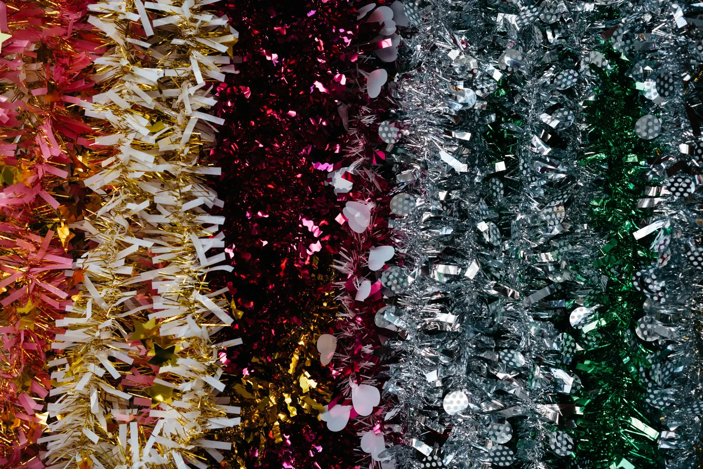 Vibrant tinsel rows in pink, gold, red, silver, and green for holiday decor.