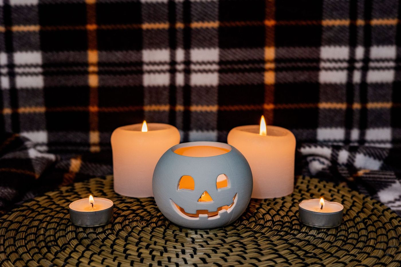 Warm and inviting Halloween setup with a decorative pumpkin and candles.