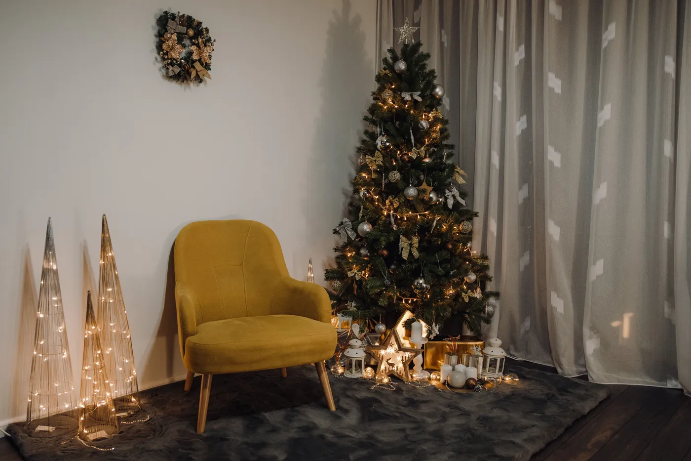 Warm indoor Christmas scene with a decorated tree, yellow chair, and festive lights.