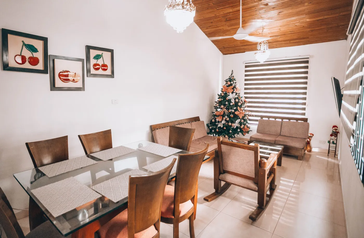 Warm living room featuring a decorated Christmas tree and modern furniture for a festive season.
